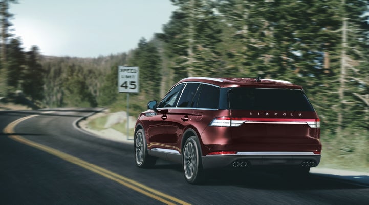 A 2024 Lincoln Aviator® SUV is being driven on a winding mountain road | Griffin Lincoln in Tifton GA